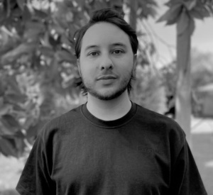 Headshot of a man outdoors in a t-shirt