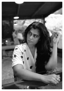 Black and white photograph of a person with long dark hair looking off to the side