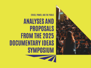 Photograph of person standing in front of a group of people seated